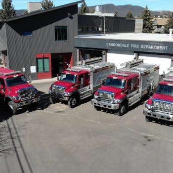 Three fire trucks outside the Carbondale Fire Department building.