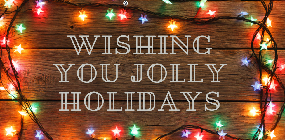 Colorful holiday lights on wood with the text "Wishing You Jolly Holidays."