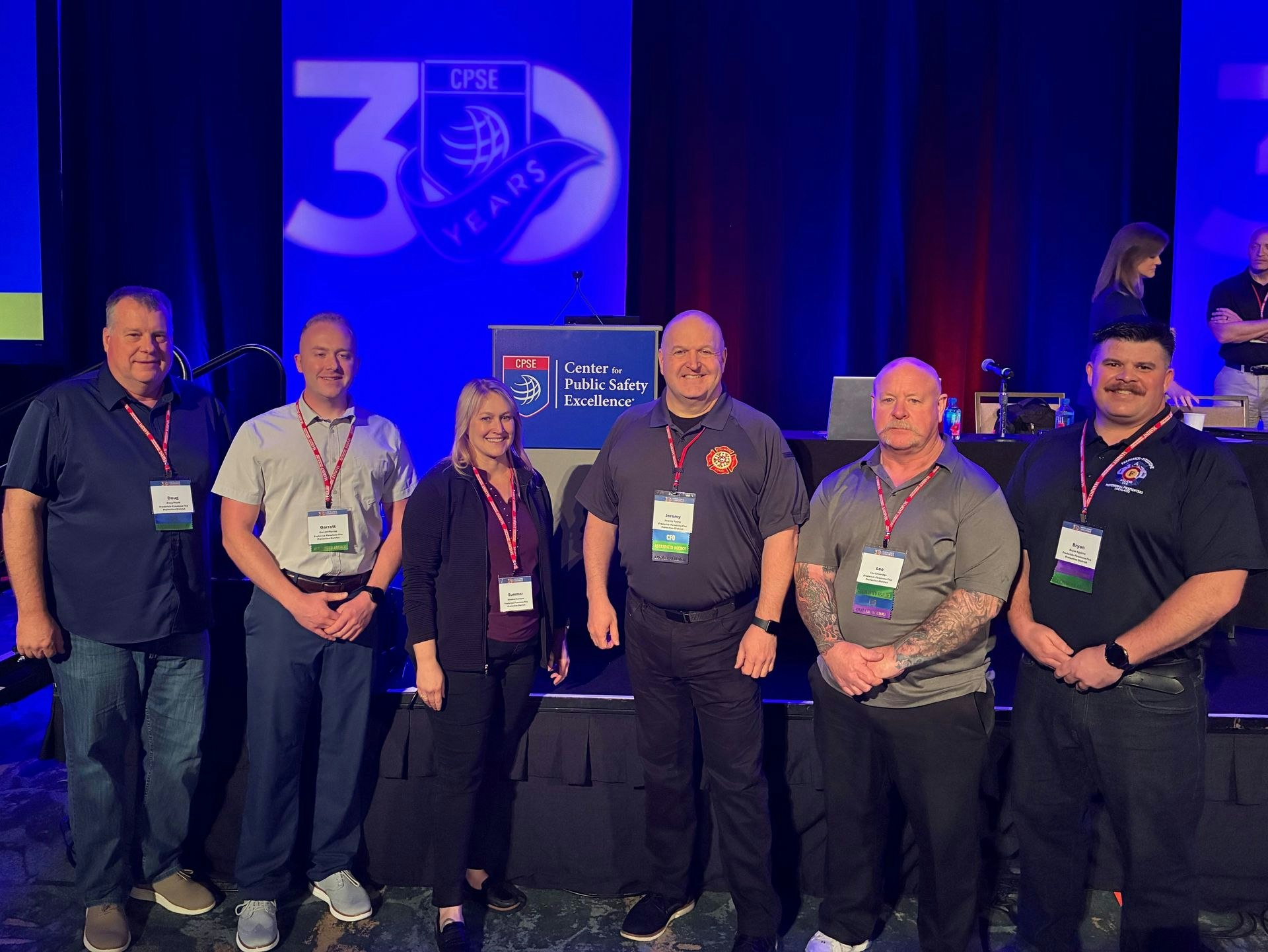 A group of professionals posing at an event celebrating 30 years of the Center for Public Safety Excellence.