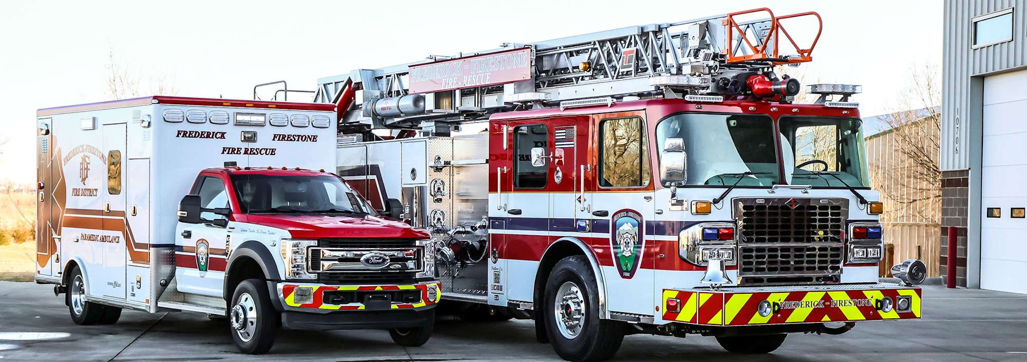 An ambulance and a fire truck parked next to each other.