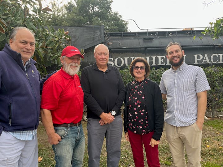 May contain: clothing, pants, people, person, jeans, t-shirt, face, head, photography, portrait, accessories, glasses, belt, adult, male, man, baseball cap, cap, hat, blouse, wristwatch, plant, tree, shirt, knitwear, sweater, vegetation, coat, jacket, and blazer