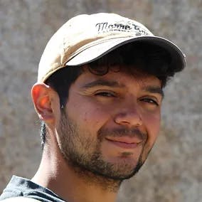 May contain: baseball cap, cap, clothing, hat, head, person, face, dimples, adult, male, and man