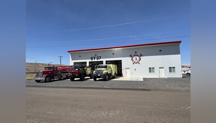 Fire station with three fire trucks parked in front, labeled ST-37.