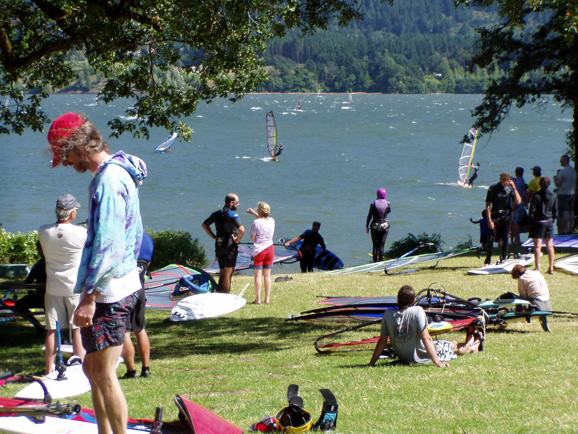 May contain: clothing, shorts, summer, person, transportation, vehicle, watercraft, nature, outdoors, sea, water, back, body part, boat, sea waves, grass, plant, helmet, footwear, shoe, accessories, and glasses