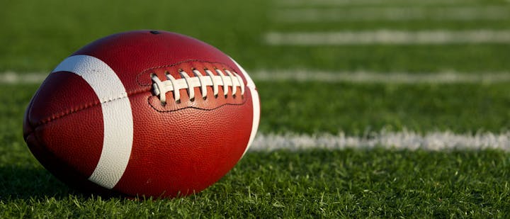 May contain: field, sport, team, football, team sport, and sports