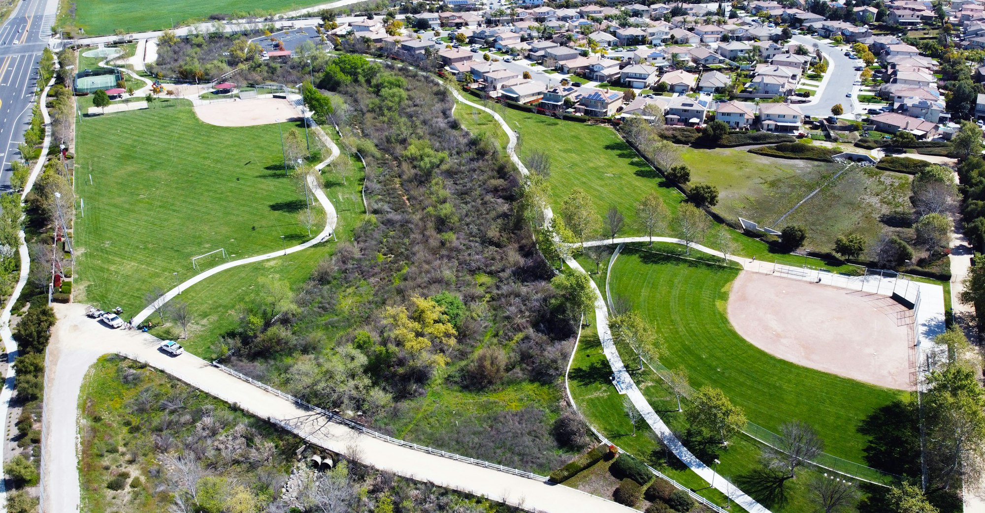 May contain: scenery, nature, outdoors, landscape, aerial view, road, urban, building, neighborhood, and intersection. Abelia Sports Park