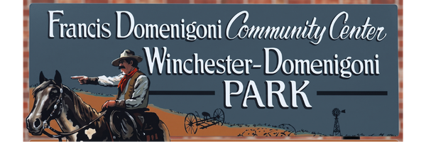 A sign for the Francis Domenigoni Community Center and Winchester-Domenigoni Park featuring a cowboy on horseback.