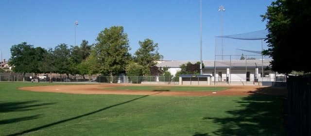 May contain: building, softball, team sport, baseball, baseball field, sports, arena, team, and sport