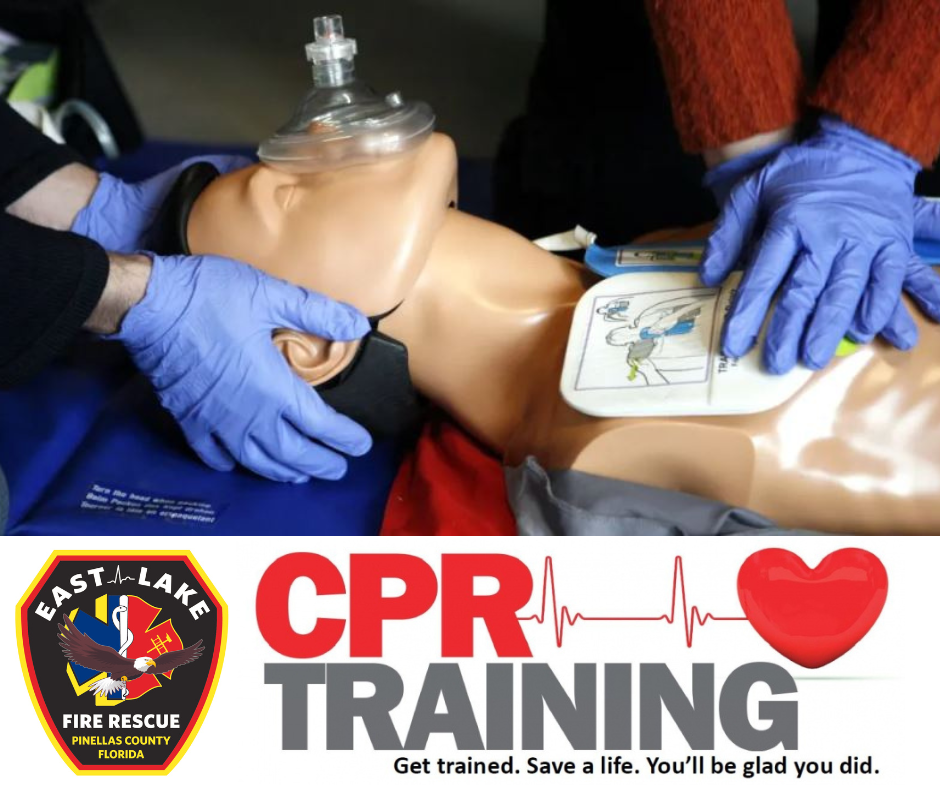 CPR training demonstration with a mannequin and defibrillator pads.