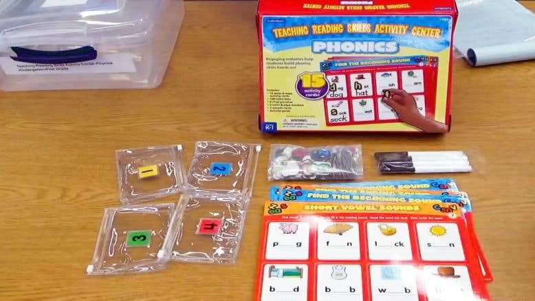 Phonics activity kit with cards, tokens, and materials designed for teaching reading skills to kids.