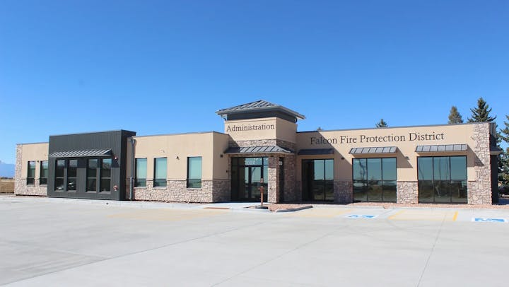 May contain: office building, building, parking lot, blue sky