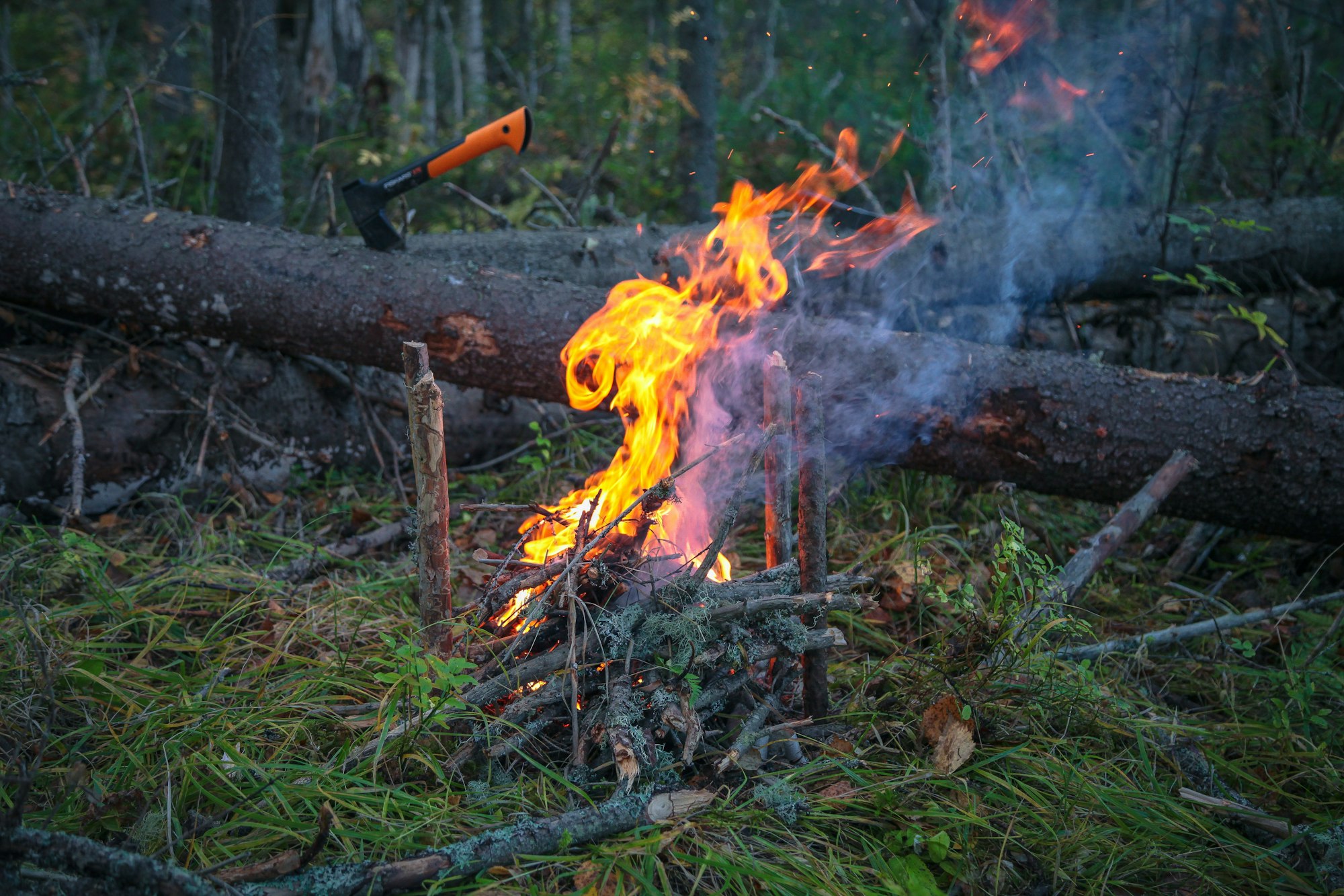 May contain: fire, flame, axe, device, tool, and weapon