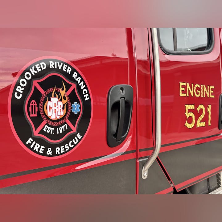 Fire truck door with "Crooked River Ranch Fire & Rescue" logo and "Engine 521" text.