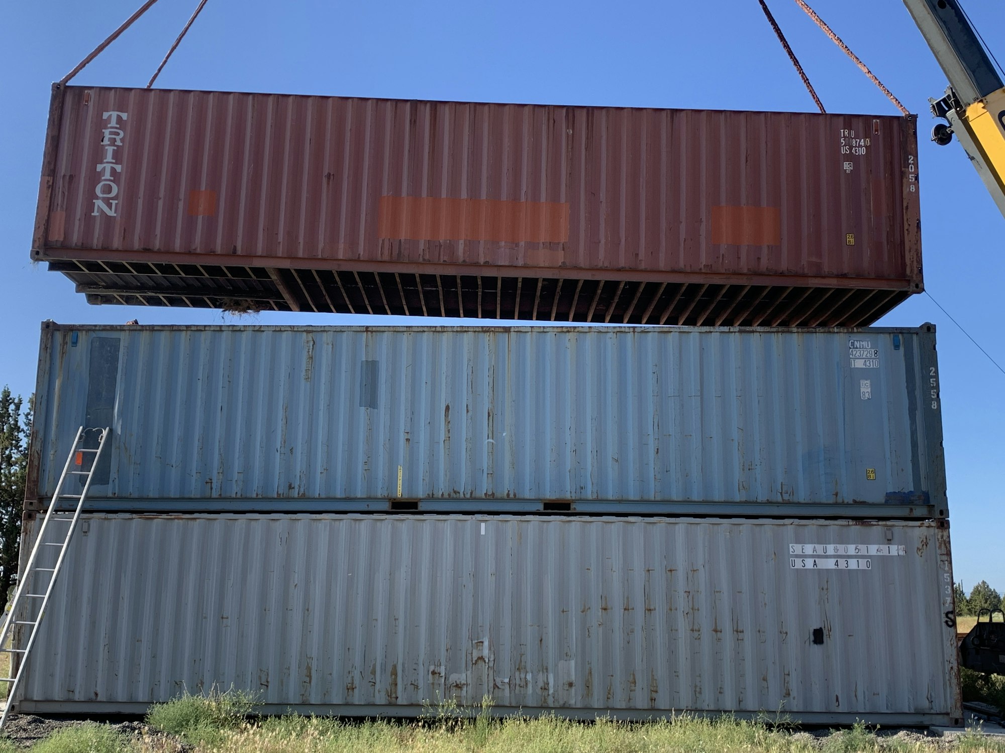 May contain: shipping container and gate