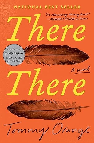 Book cover of "There There" by Tommy Orange, featuring two feathers on an orange background.