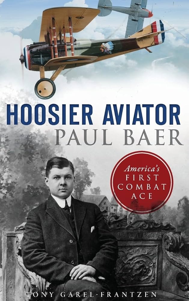 The image features a book cover titled "Hoosier Aviator: Paul Baer," highlighting America's first combat ace.