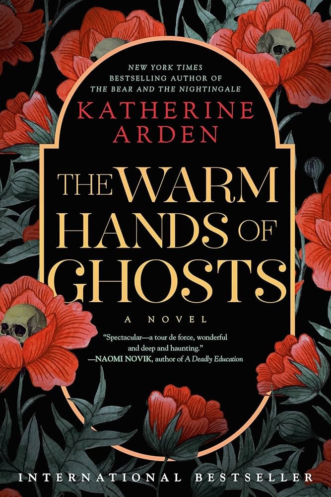 The image is a book cover for "The Warm Hands of Ghosts" by Katherine Arden, featuring floral designs and a skull.