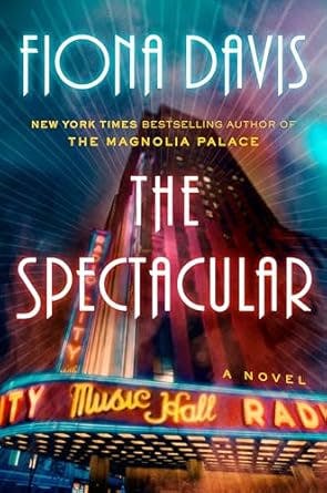 Book cover: "The Spectacular" by Fiona Davis, featuring an illuminated theater marquee and vibrant lights.