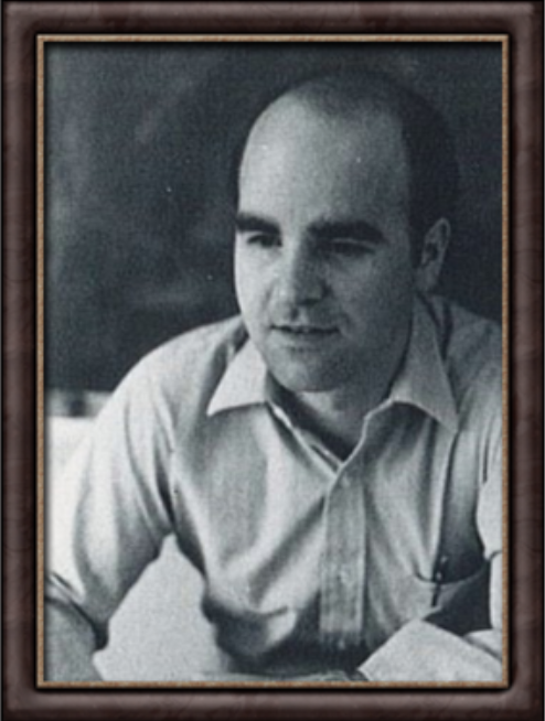 A vintage framed portrait of a man with a receding hairline wearing a light-colored shirt.