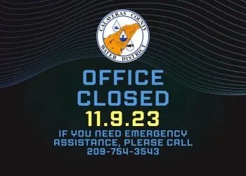 A sign announcing an office closure on 11.9.23 with a contact number for emergency assistance.