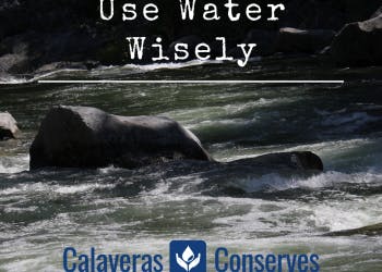 A river with rocks and a "Use Water Wisely" conservation message.