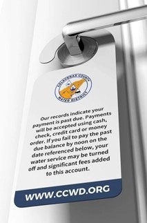 A door tag warning about past due payment and potential water service termination from CCWD.