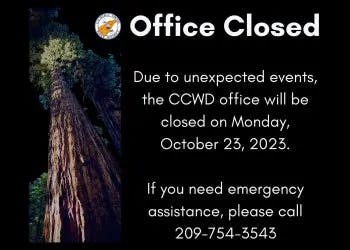 A sign saying "Office Closed" with closure details and an emergency contact number, plus an image of a tree.