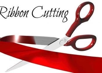 Scissors cutting a red ribbon with the words "Ribbon Cutting" above.