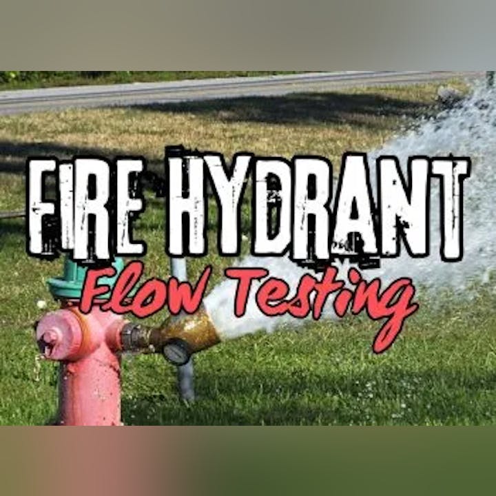 Water spraying from a fire hydrant for flow testing.