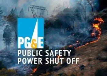 A wildfire near power lines with a "PG&E Public Safety Power Shut Off" sign, indicating electricity cut-off for safety.