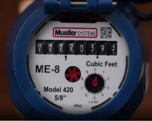 A water meter showing usage in cubic feet, labeled "Mueller Systems ME-8 Model 420."