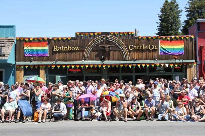 May contain: parade, person, accessories, bag, handbag, clothing, hat, footwear, shoe, and pride parade