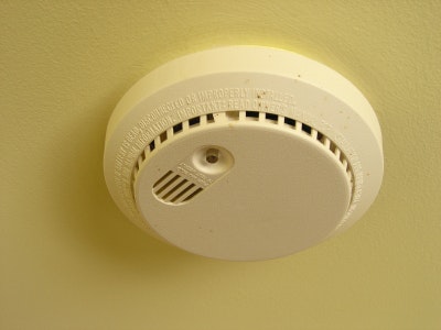A ceiling-mounted smoke detector.