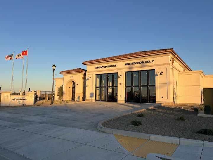 Fire Station No. 2 labeled "Mountain House" with flags and a lit street lamp.