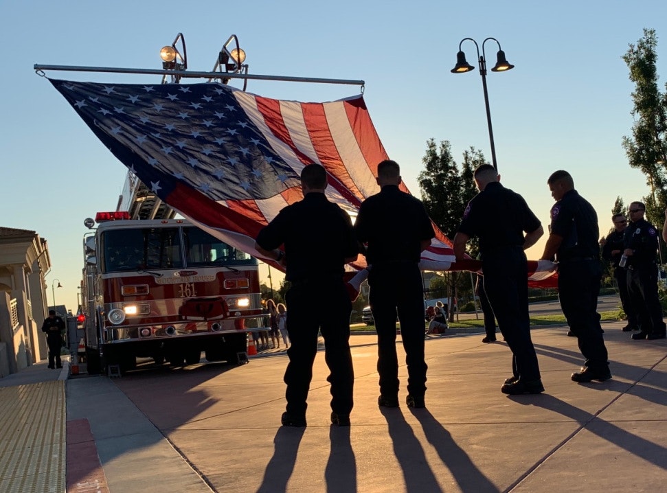 May contain: fire truck, flag of the United States, people