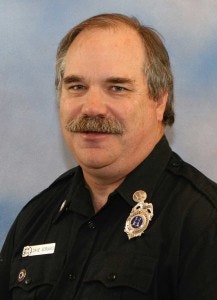 May contain: police officer, person, officer, captain, man, adult, male, badge, symbol, and logo