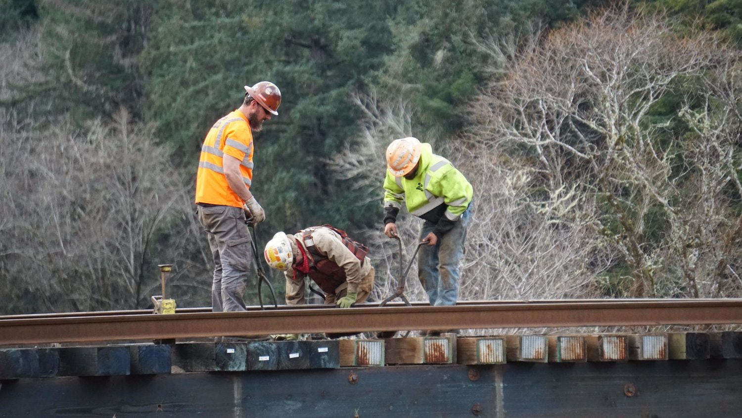 May contain: person, worker, clothing, hardhat, helmet, glove, adult, male, and man