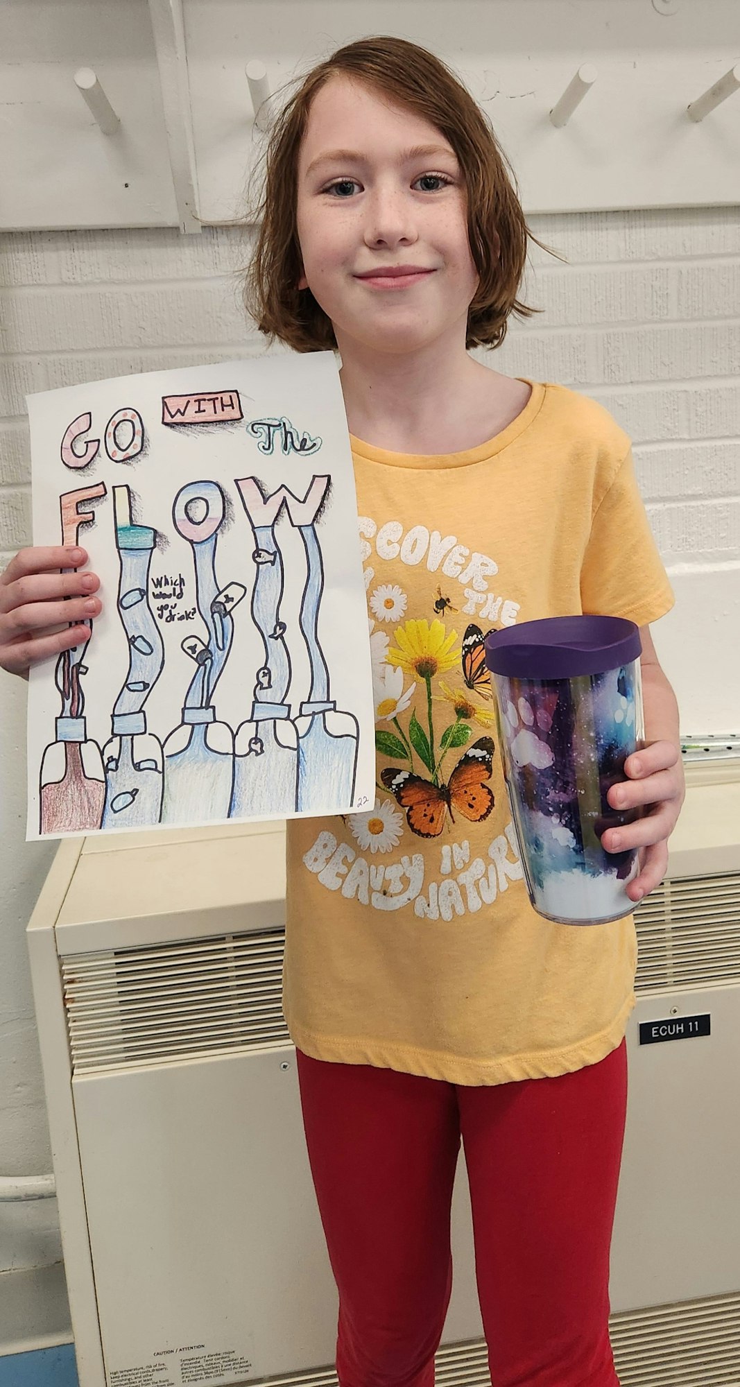 May contain: clothing, t-shirt, face, head, person, photography, portrait, sleeve, and cup