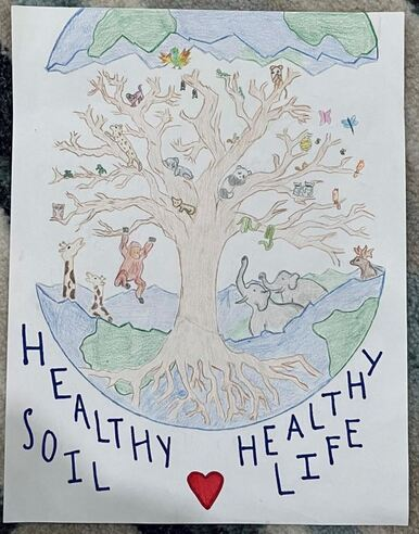 A child's drawing of a tree with various animals and the words "Healthy Soil Healthy Life" at the bottom.