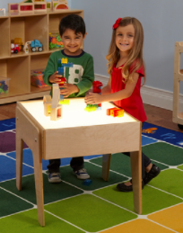 May contain: kindergarten, wood, furniture, table, boy, child, male, person, floor, female, girl, plywood, and play area