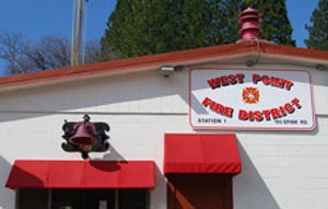 A fire station building with a sign "West Point Fire District."