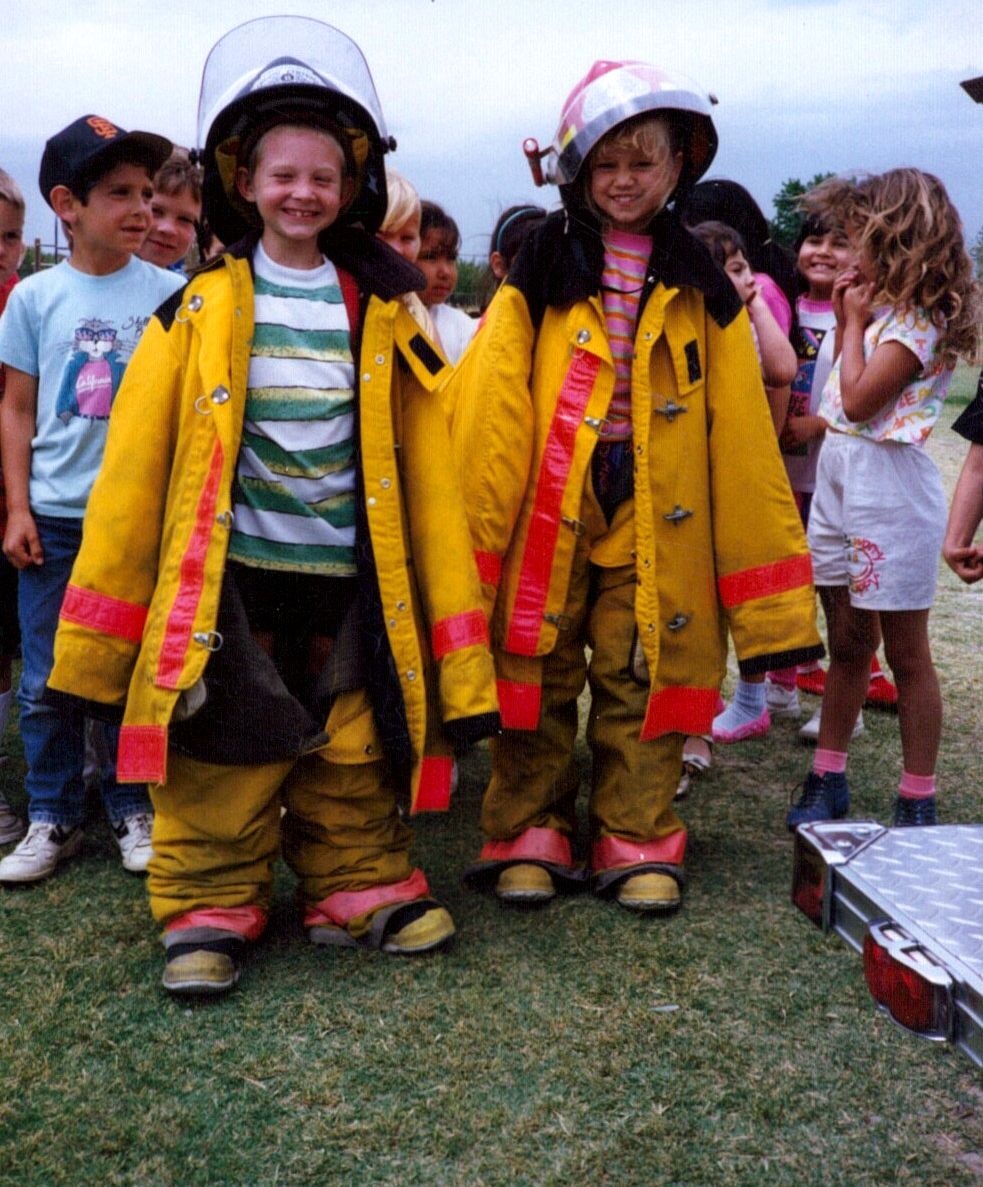 Children wearing fire turnouts apart of a station tour.