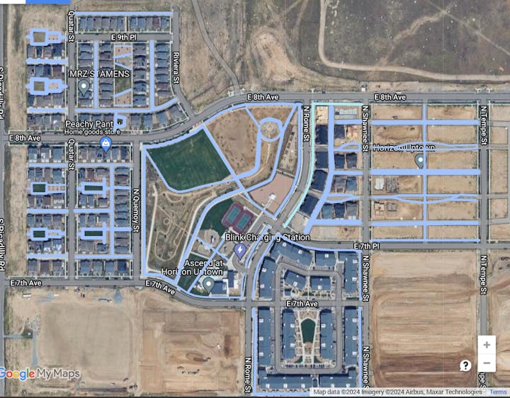 Aerial view of an urban area with streets, buildings, and labelled business locations.