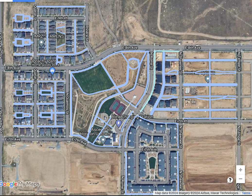 Aerial view of an urban area with streets, buildings, and labelled business locations.
