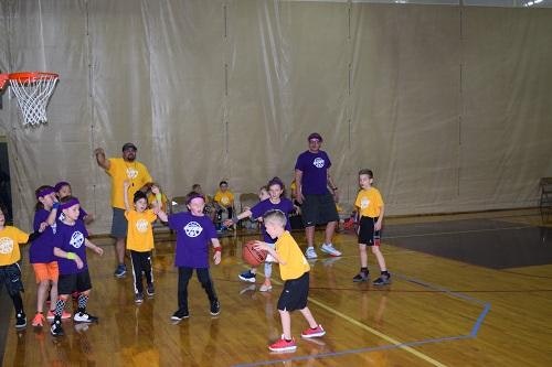 young children playing basketball