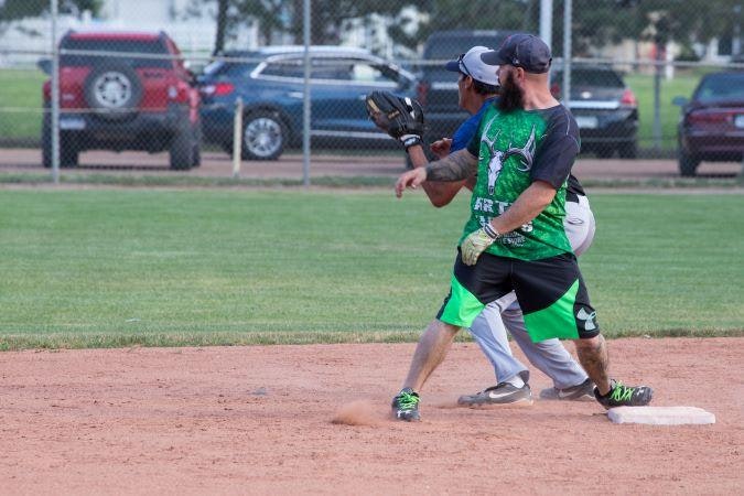 adult softball players on base