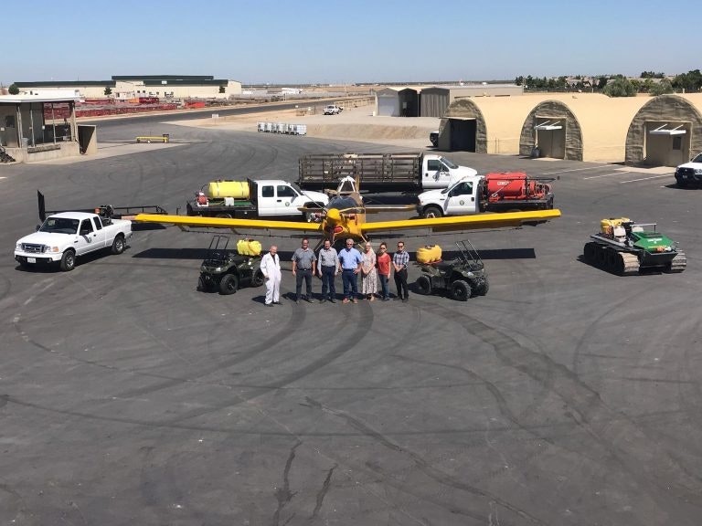 A few of our crew members standing in front of vehicles we use for larvicide and adulticide applications