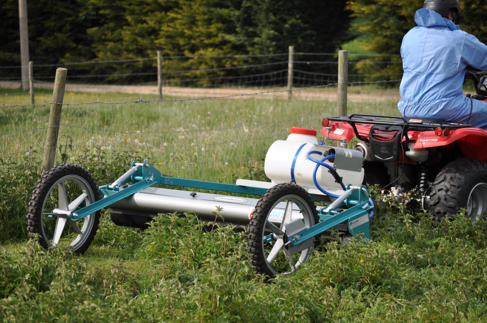 May contain: grass, plant, lawn, machine, spoke, helmet, adult, male, man, person, motorcycle, transportation, and vehicle