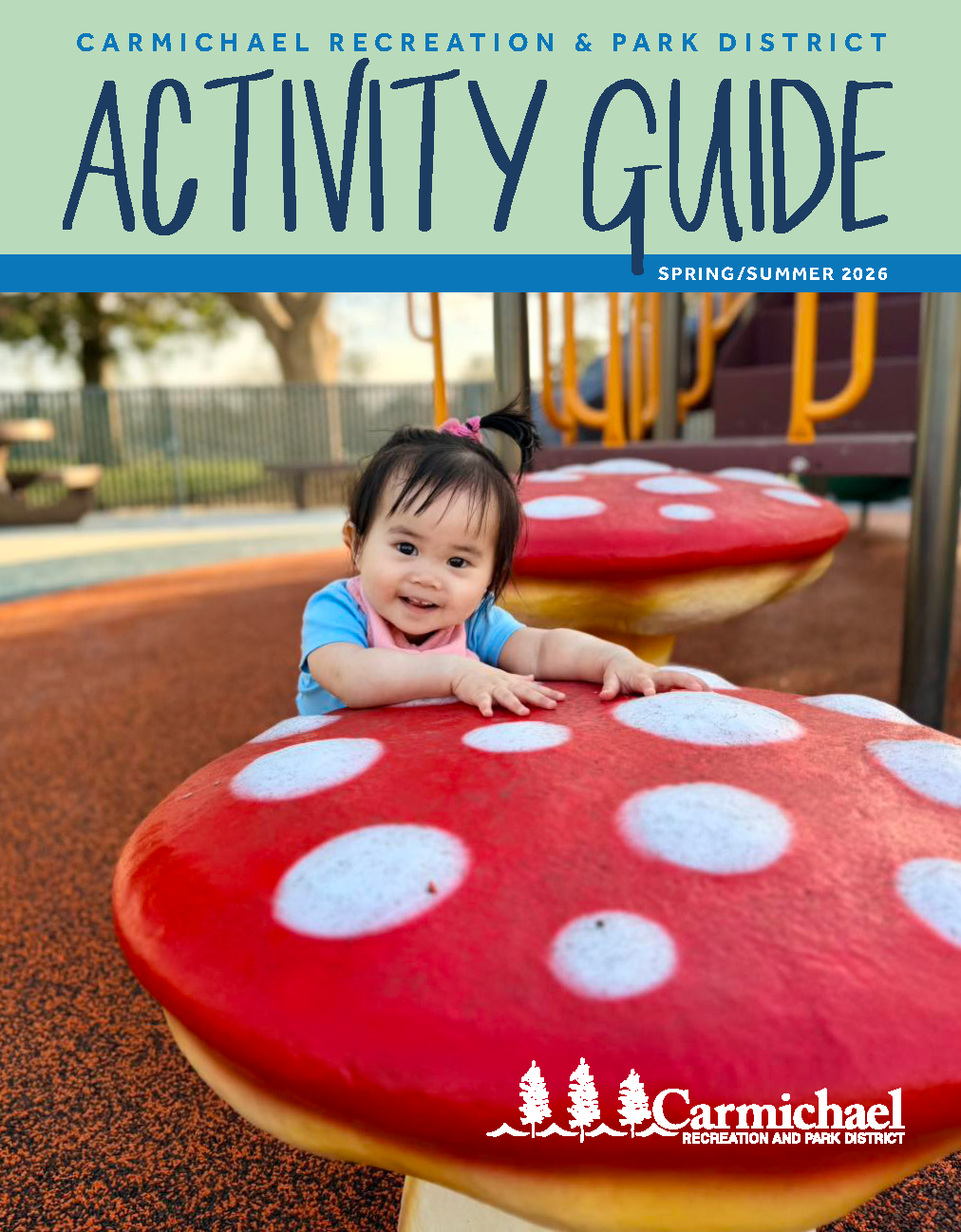 A young child smiles while playing on a colorful mushroom-shaped play structure in a park, featured in a recreation guide.