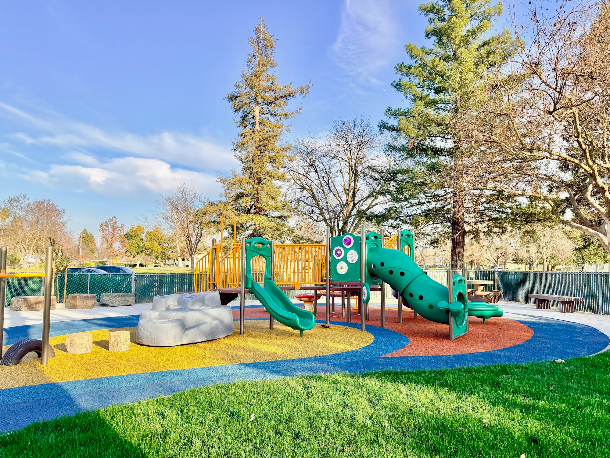May contain: outdoor play area, outdoors, play area, bench, furniture, grass, nature, park, and plant